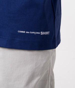 CDG Script Hem Logo T-Shirt in navy. Detail shot at EQVVS.