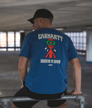 Carhartt WIP Relaxed Fit Duckin' T-Shirt in Acapulco with back print. Campaign shot at EQVVS.