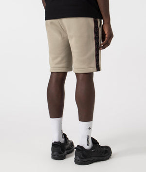 Fred Perry Taped Sweat Shorts in Warm Grey/Brick with side tape detail. Back angle shot at EQVVS.