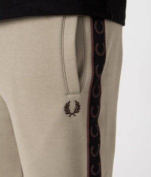 Fred Perry Taped Sweat Shorts in Warm Grey/Brick with side tape detail. Detail shot at EQVVS.