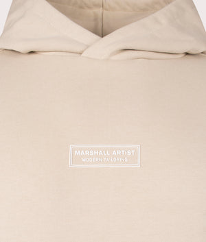 Marshall Artist Siren Overhead Hoodie in 010 sandstone 100% cotton chest detail shot at EQVVS