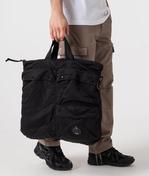 CP Company Nylon Tote Bag in Black featuring the CP Goggle Side Shot at EQVVS