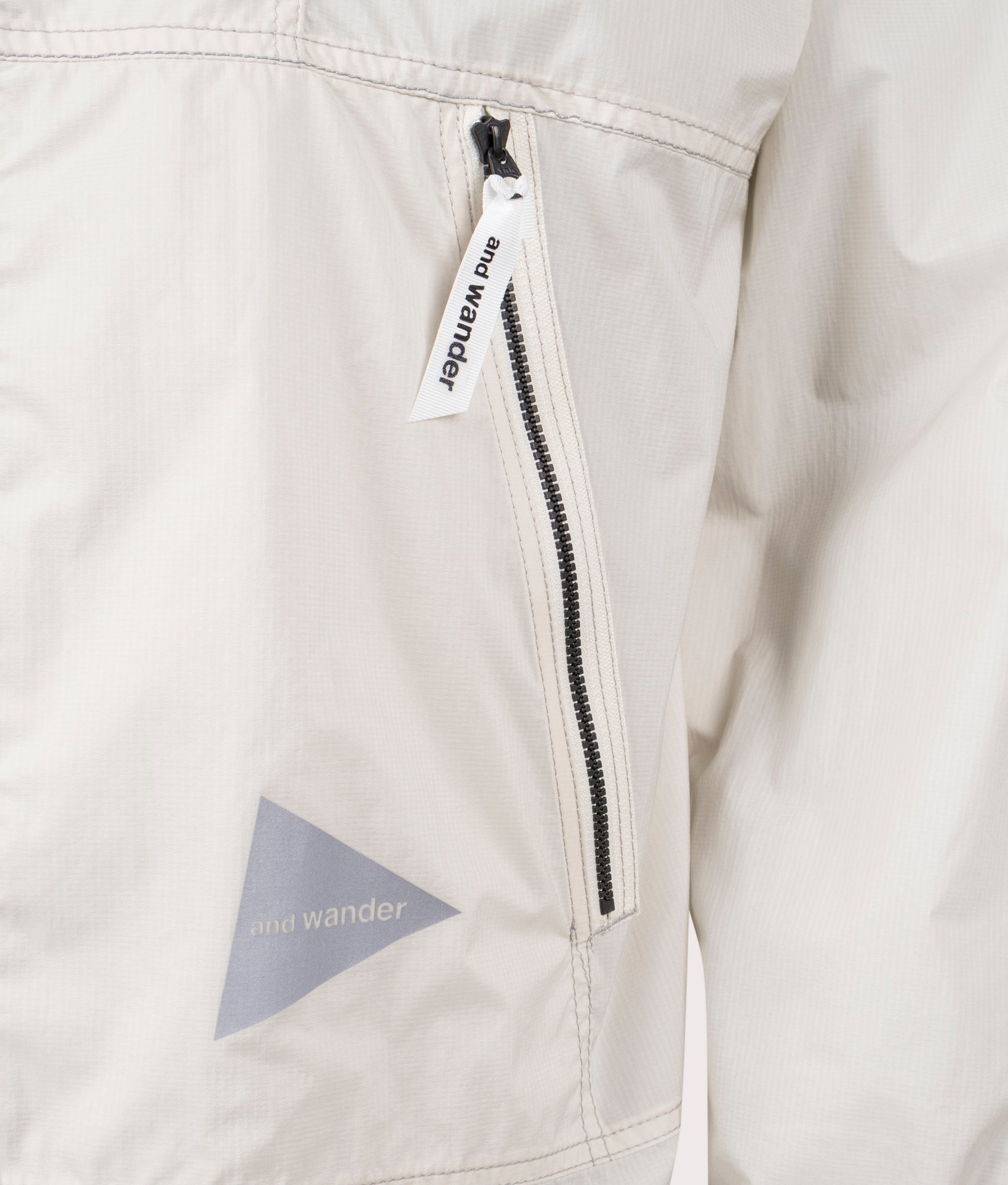 and wander Pertex Wind Jacket in Off White at EQVVS.  Detail Shot.