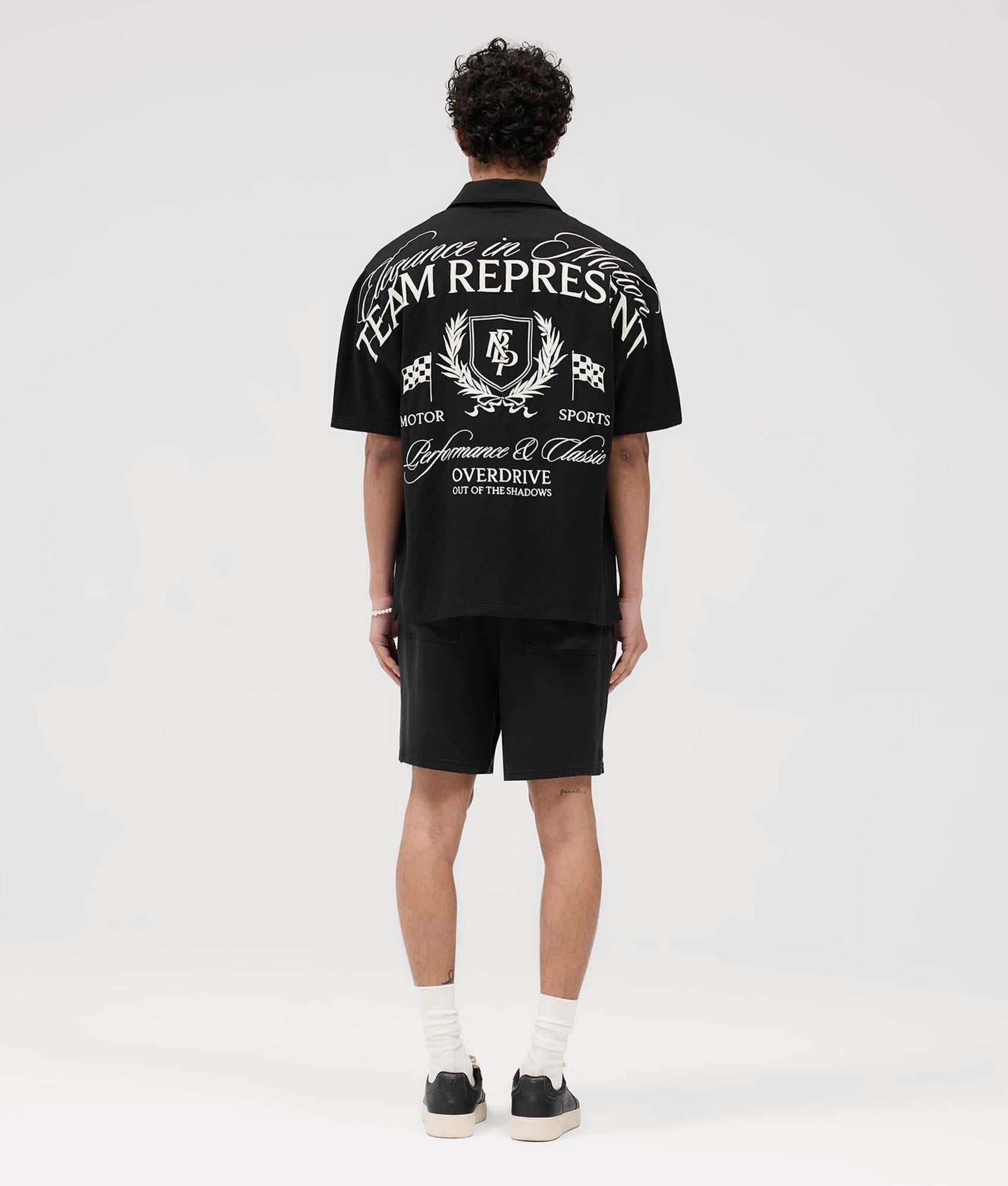 Represent Represent Crest Shorts in Black at EQVVS. Model back shot.