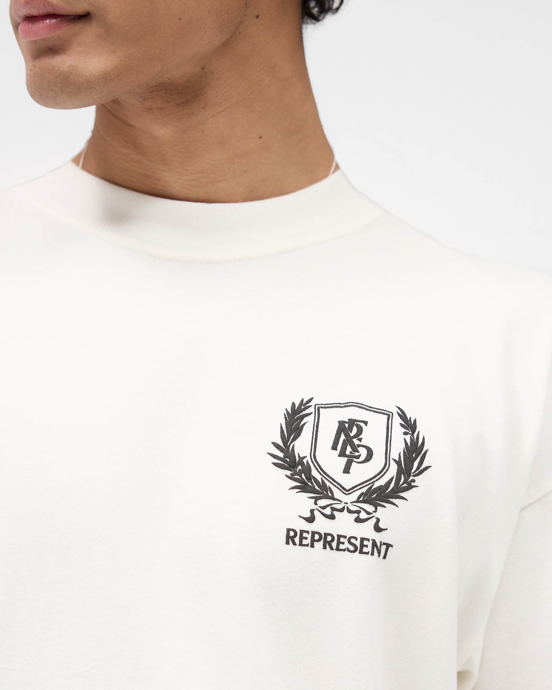 Represent Crest T-Shirt in Flat White at EQvVS. Detail Model Shot