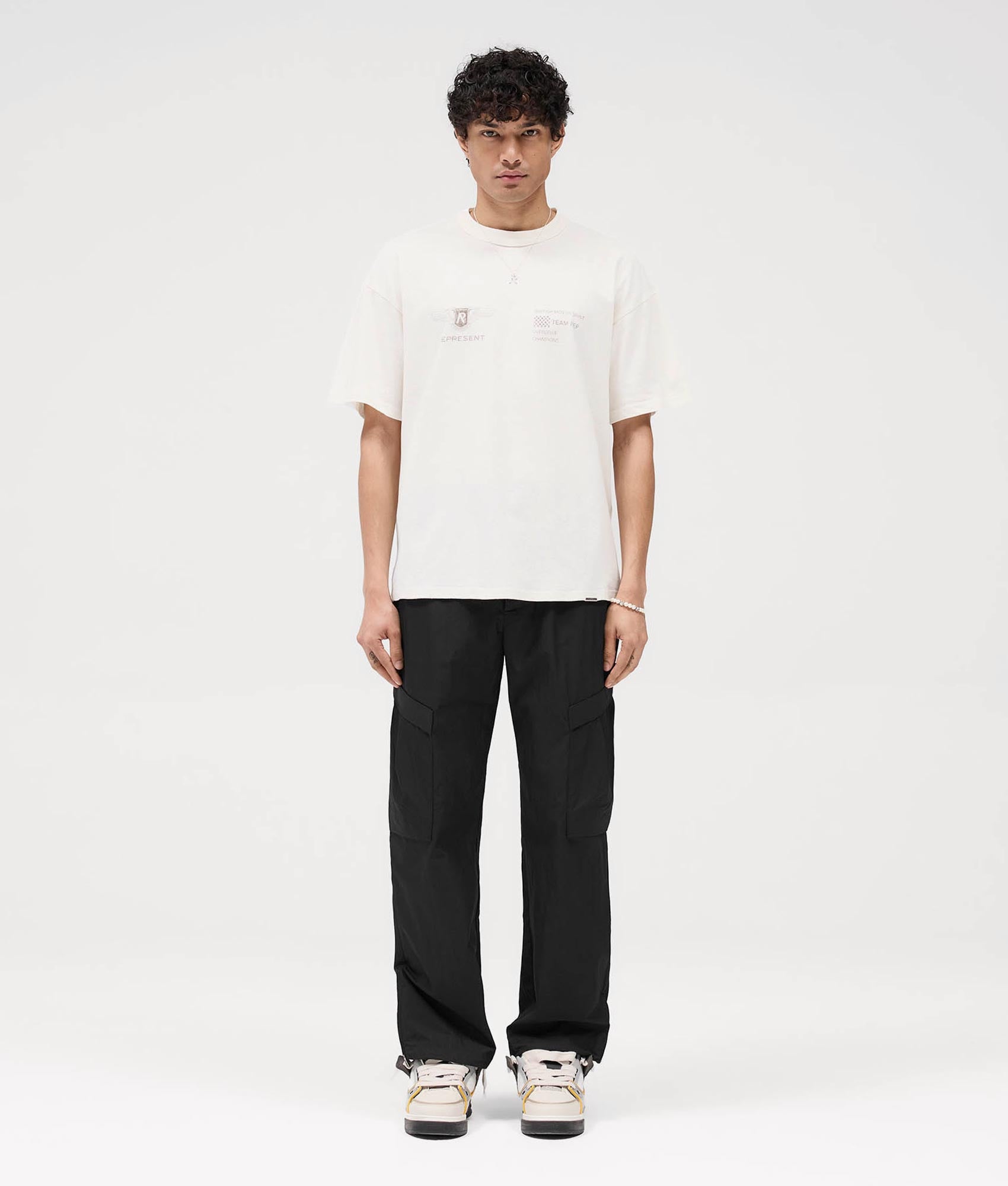 Represent Team Rep T-Shirt in Flat White at EQVVS. Front Shot model.