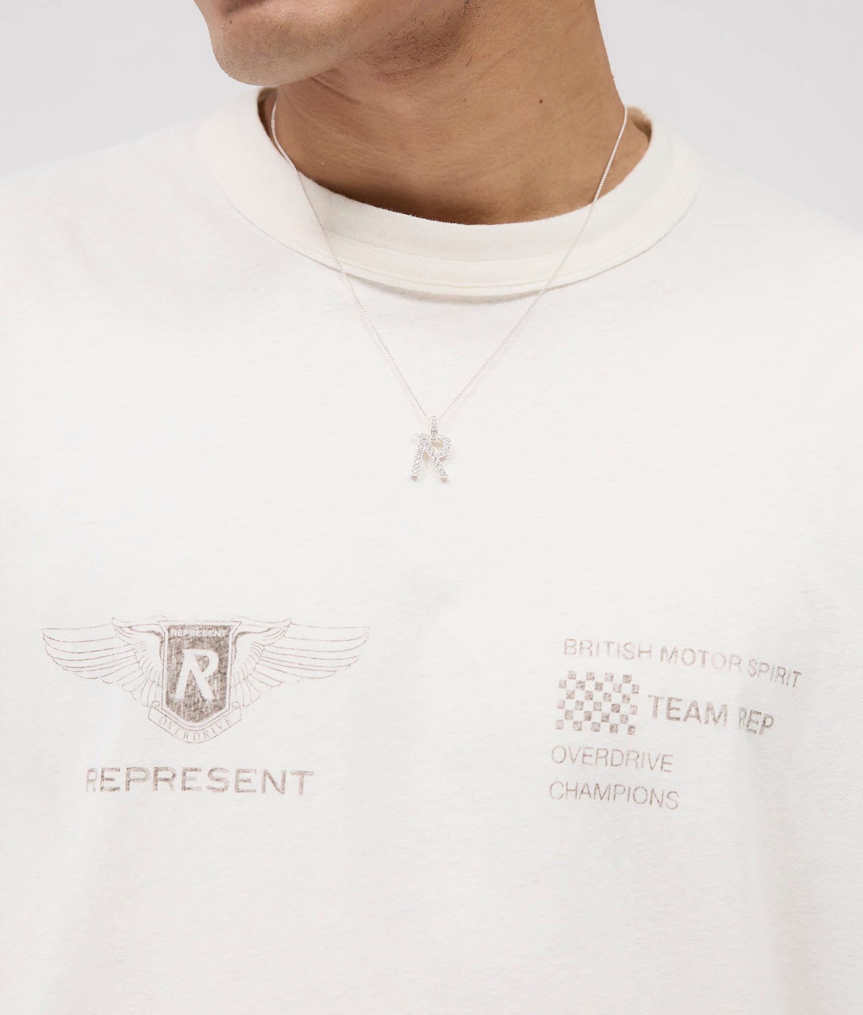 Represent Team Rep T-Shirt in Flat White at EQVVS. Detail Shot model.
