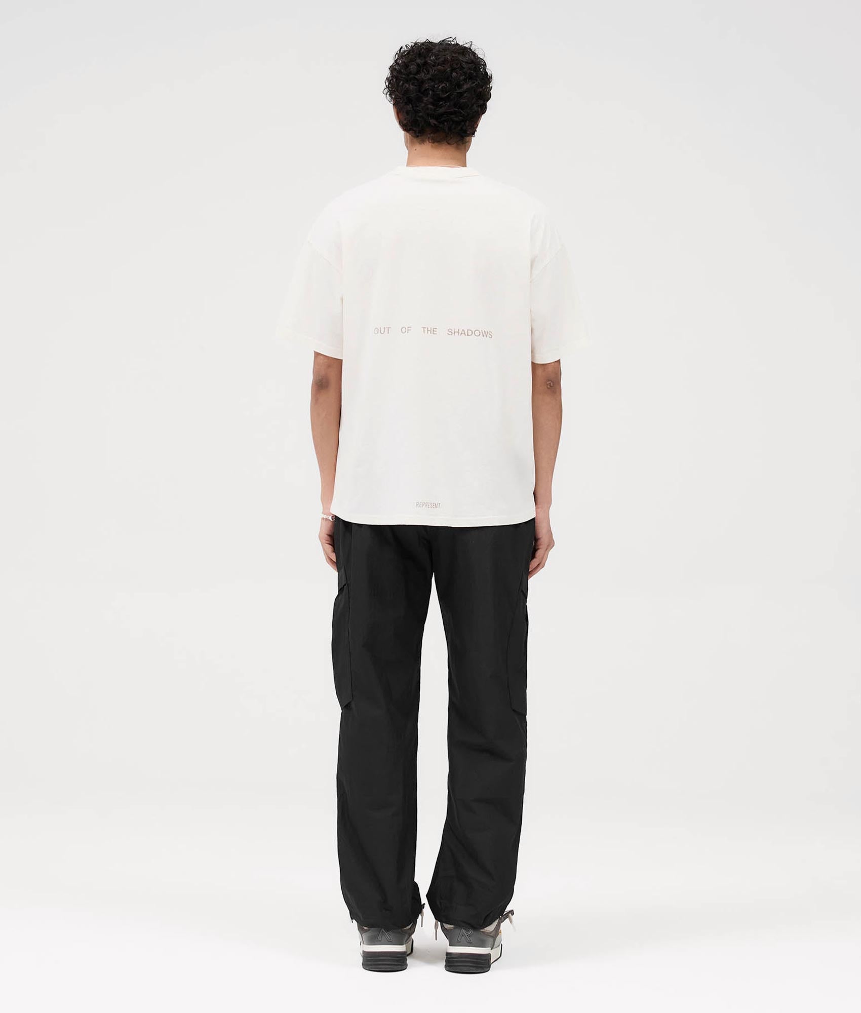 Represent Team Rep T-Shirt in Flat White at EQVVS. Back Shot model.