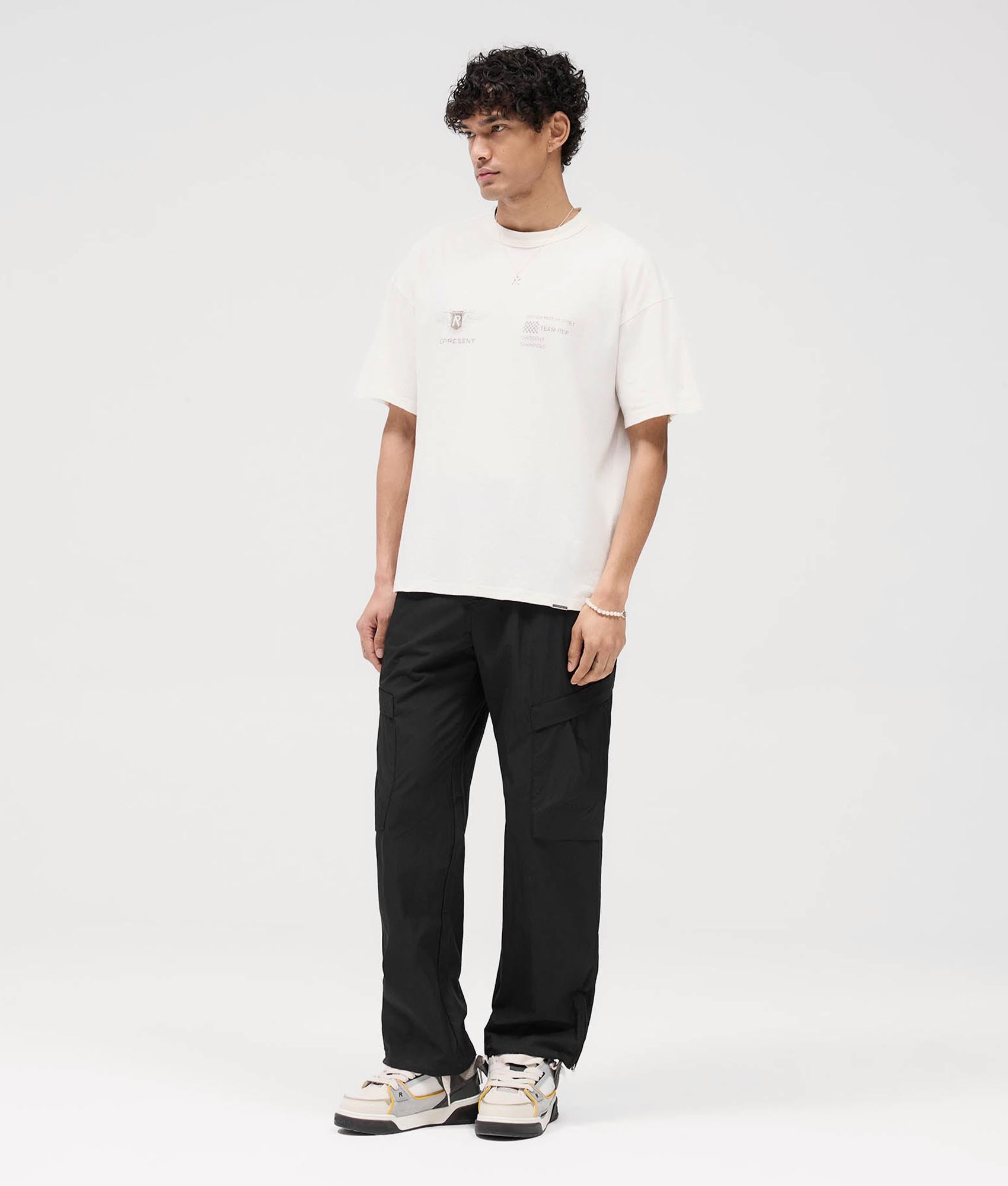 Represent Team Rep T-Shirt in Flat White at EQVVS. Angle Shot model.