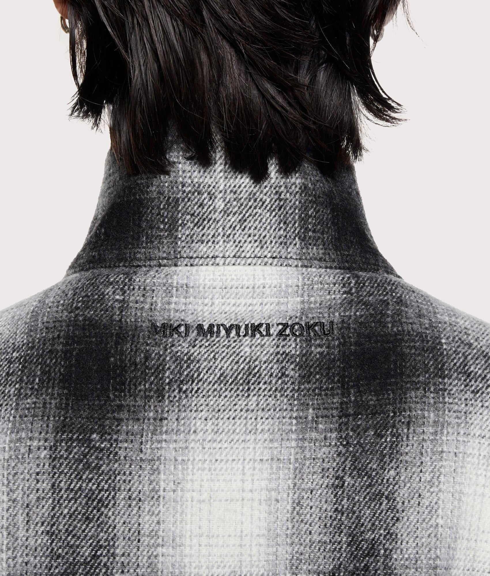MKI MIYUKI ZOKU Wool Check Track Jacket in off white at EQVVS Menswear. Detail shot.