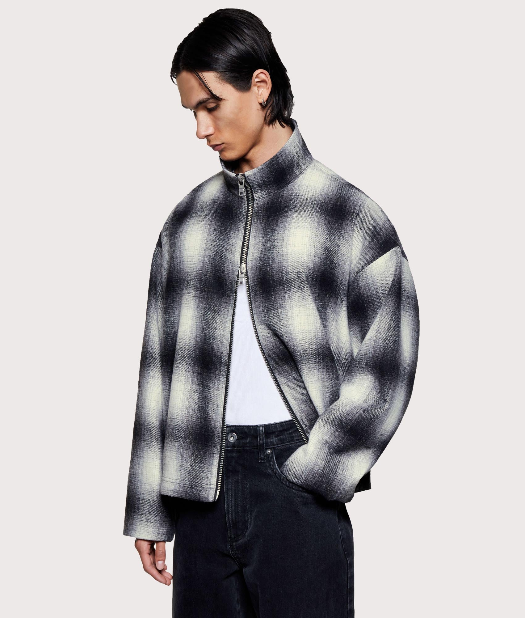 MKI MIYUKI ZOKU Wool Check Track Jacket in off white at EQVVS Menswear. Angled model front shot.