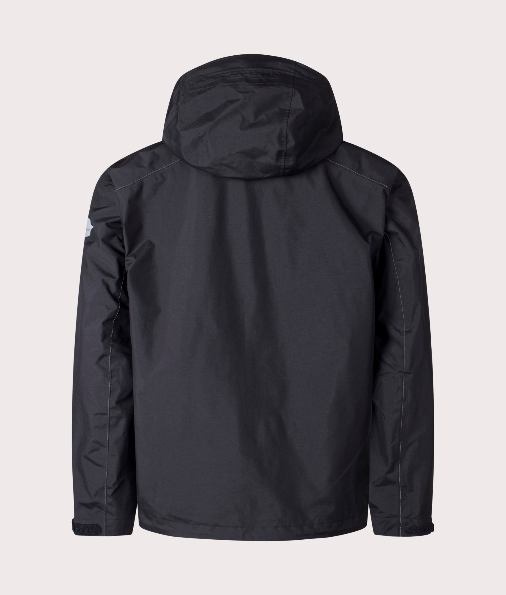 and Wander 2.5L Hiker Rain Jacket in Black. Shot at EQVVS. Back shot 