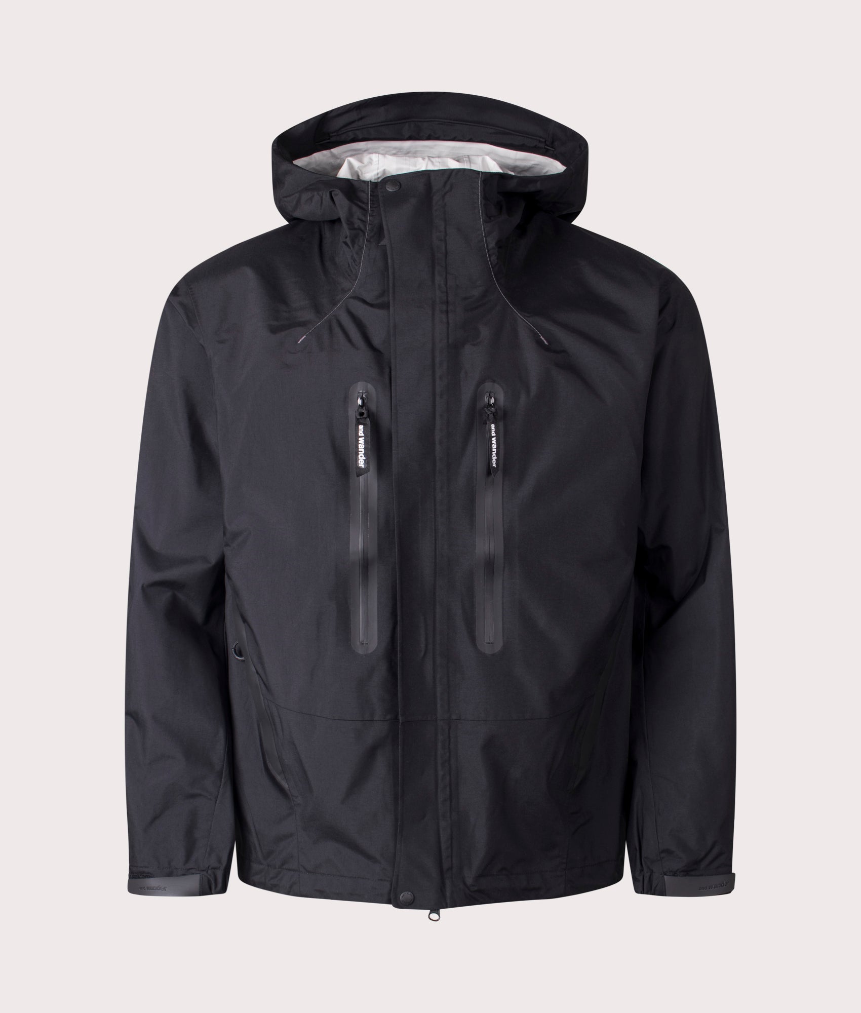 and Wander 2.5L Hiker Rain Jacket in Black. Shot at EQVVS. Front detail shot 