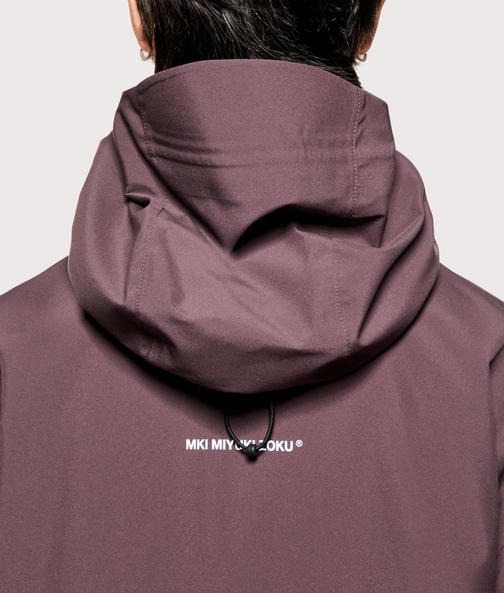 MKI MIYUKI ZOKU Shell Box Jacket in Raisin at EQVVS Menswear. Back detail shot.