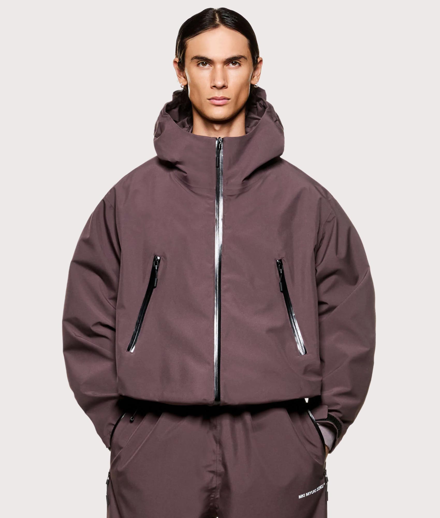 MKI MIYUKI ZOKU V3 Shell Hooded Jacket in Raisin at EQVVS Menswear. Model front shot. 