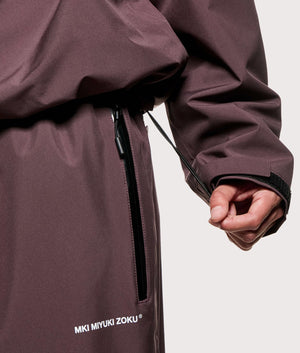 MKI MIYUKI ZOKU V3 Shell Hooded Jacket in Raisin at EQVVS Menswear. Hem detail.