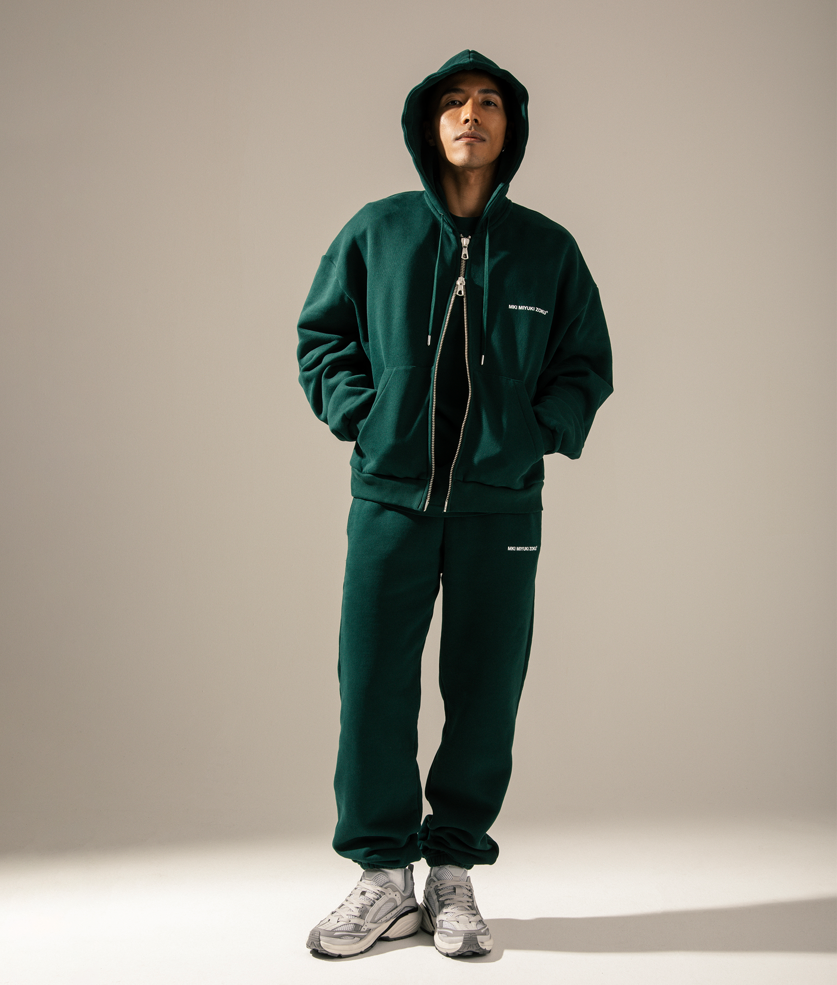 MKI MIYUKI ZOKU Oversized Uniform Zip Through Hoodie in Green at EQVVS Menswear. Campaign shot.