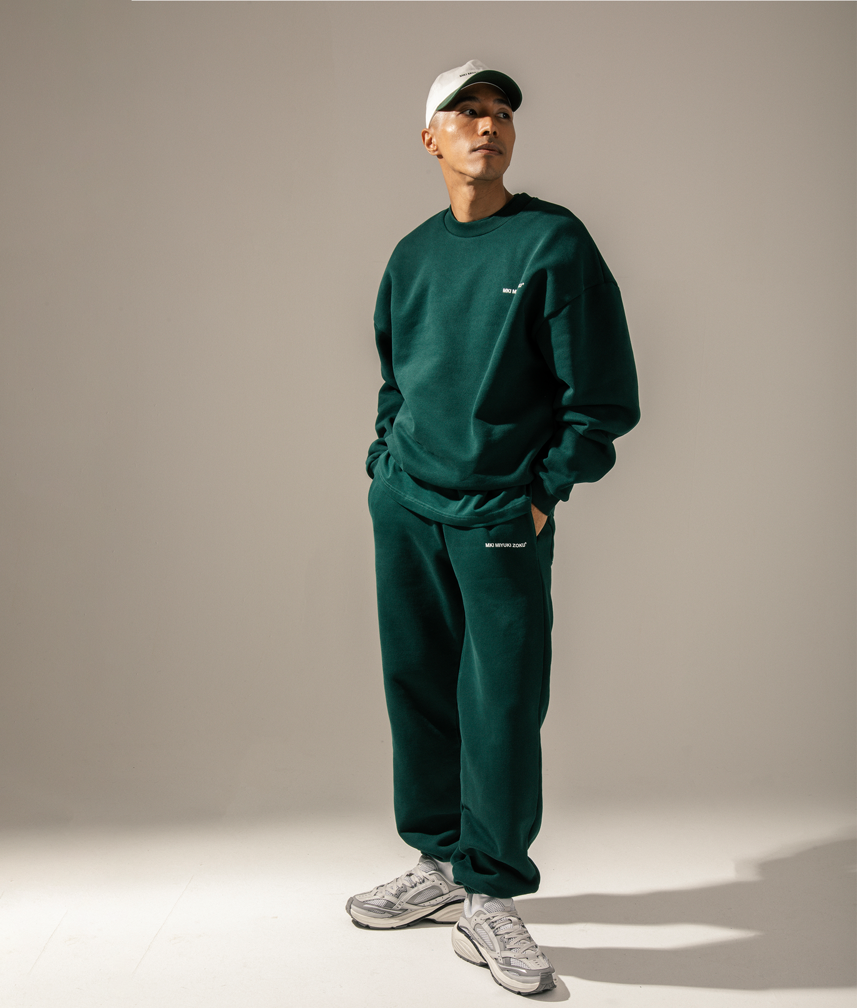 MKI MIYUKI ZOKU Oversized Uniform Crewneck Sweatshirt in Green at EQVVS Menswear. Campaign shot.