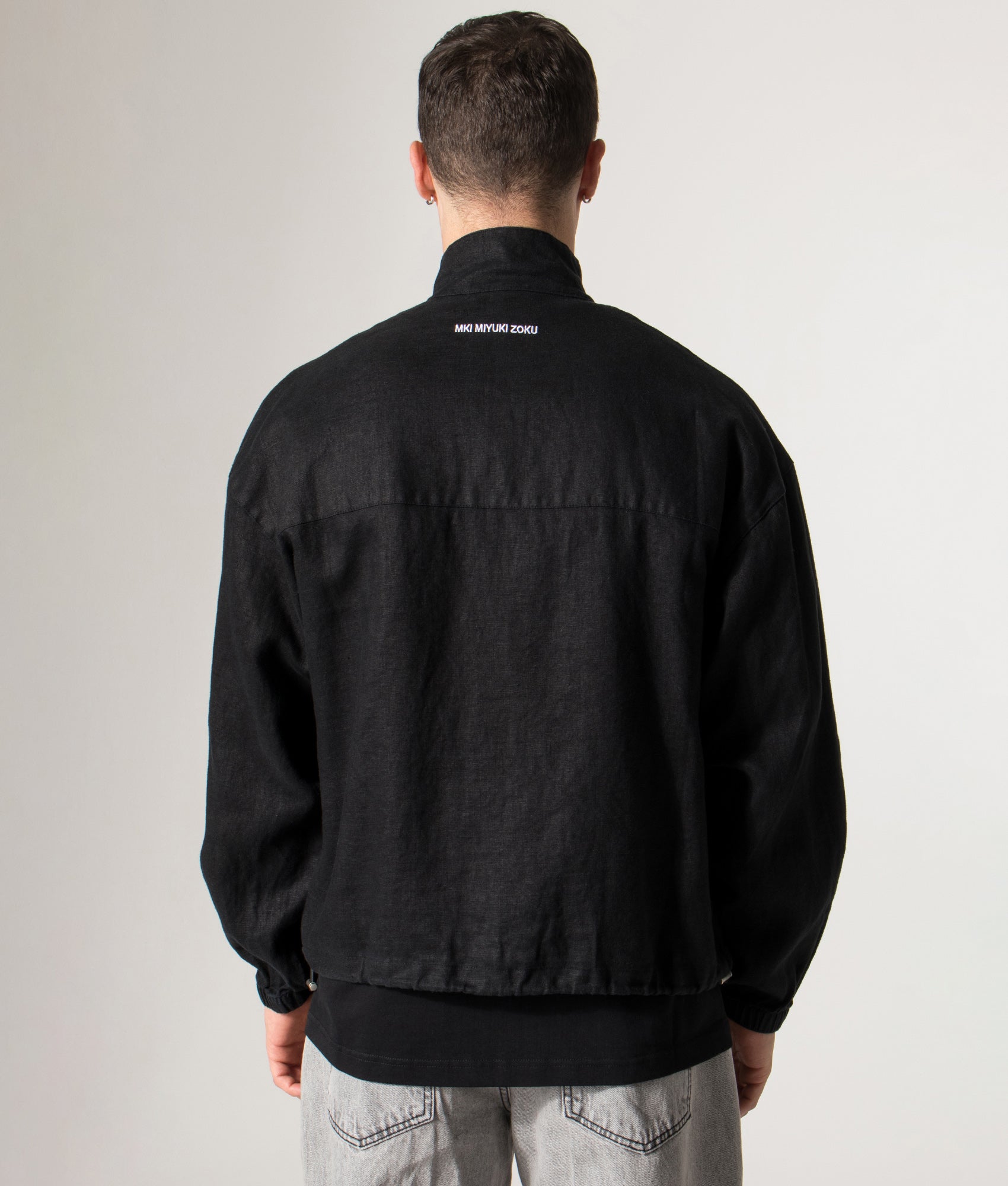 Linen Track Jacket in Black. 100% Linen | MKI MIYUKI ZOKU | Shot at EQVVS | Back model shot 
