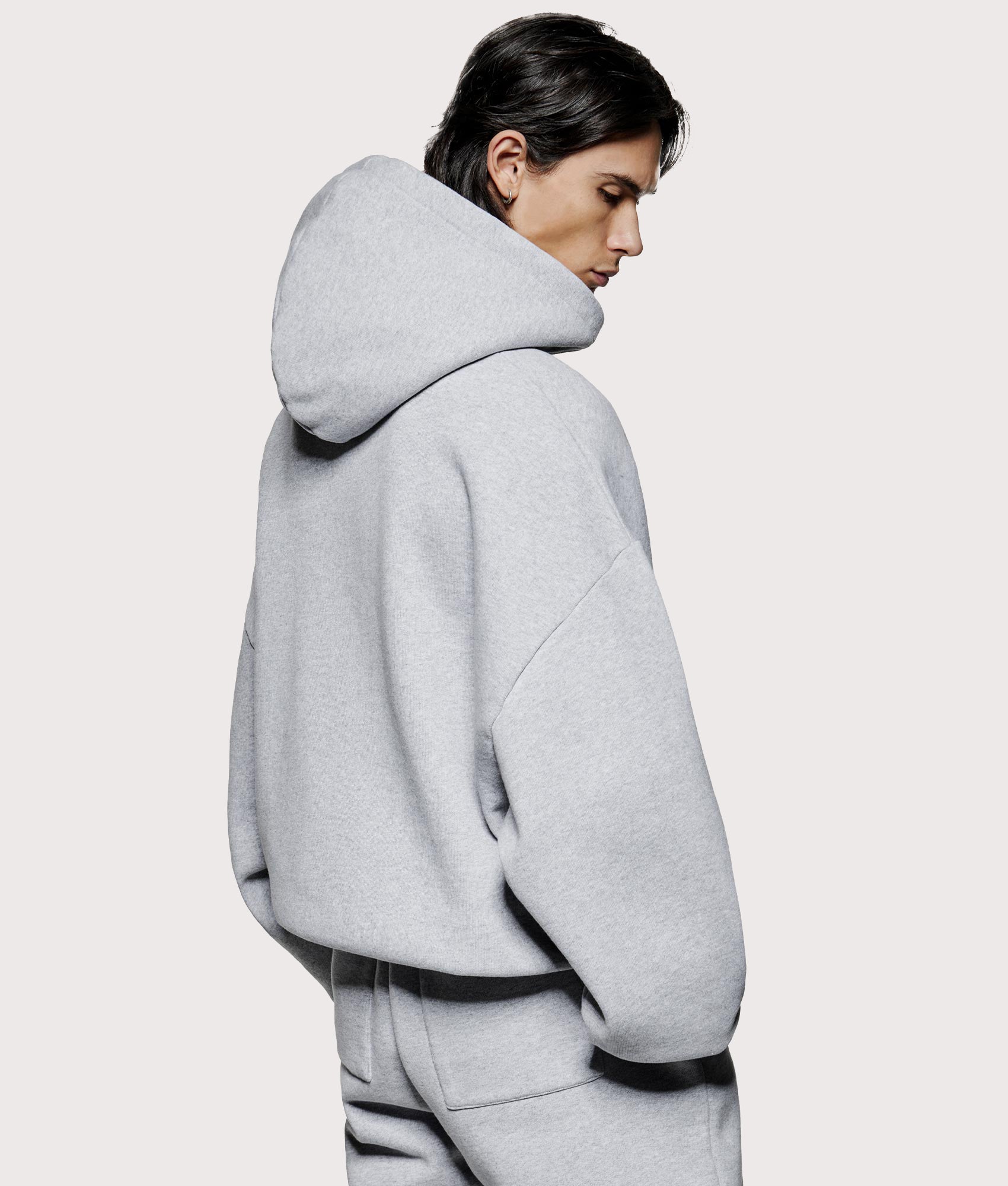 MKI MIYUKI ZOKU Oversized Uniform Hoodie at EQVVS Menswear. Model angled back shot.