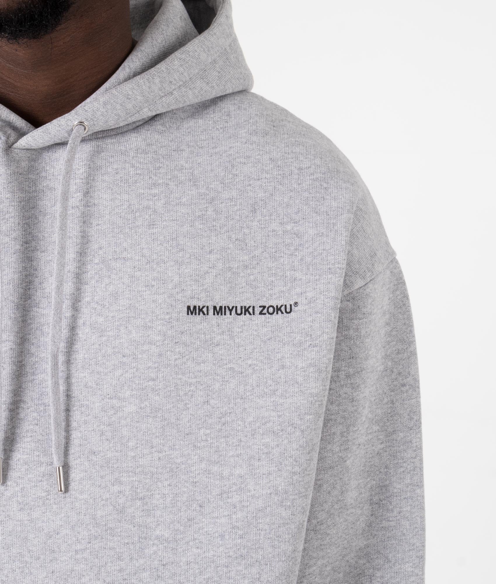 MKI MIYUKI ZOKU Oversized Uniform Hoodie at EQVVS Menswear. Detail shot.