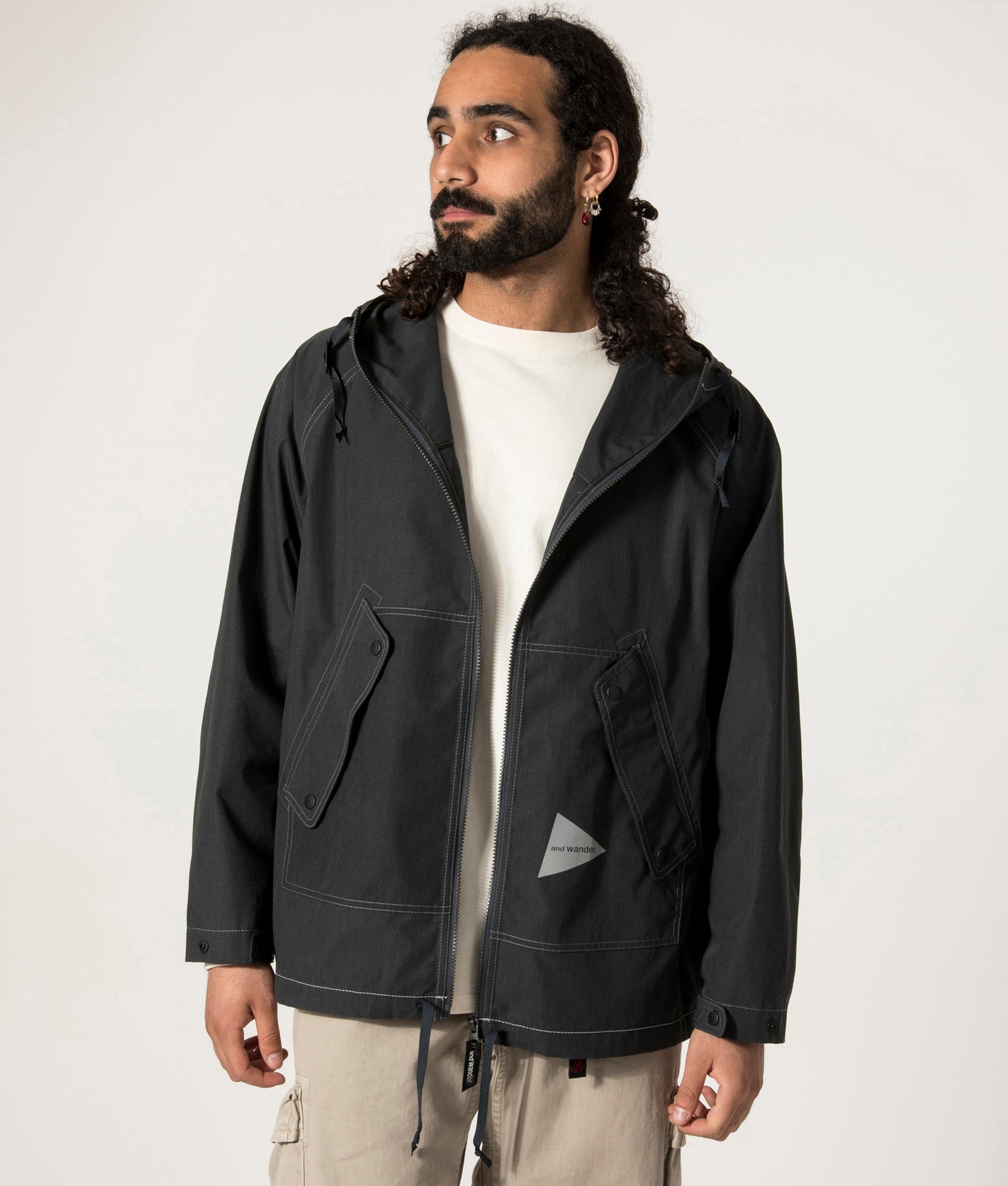 and wander Tough Aramid Hoodie in Charcoal at EQVVS. Open Jacket Model Shot.
