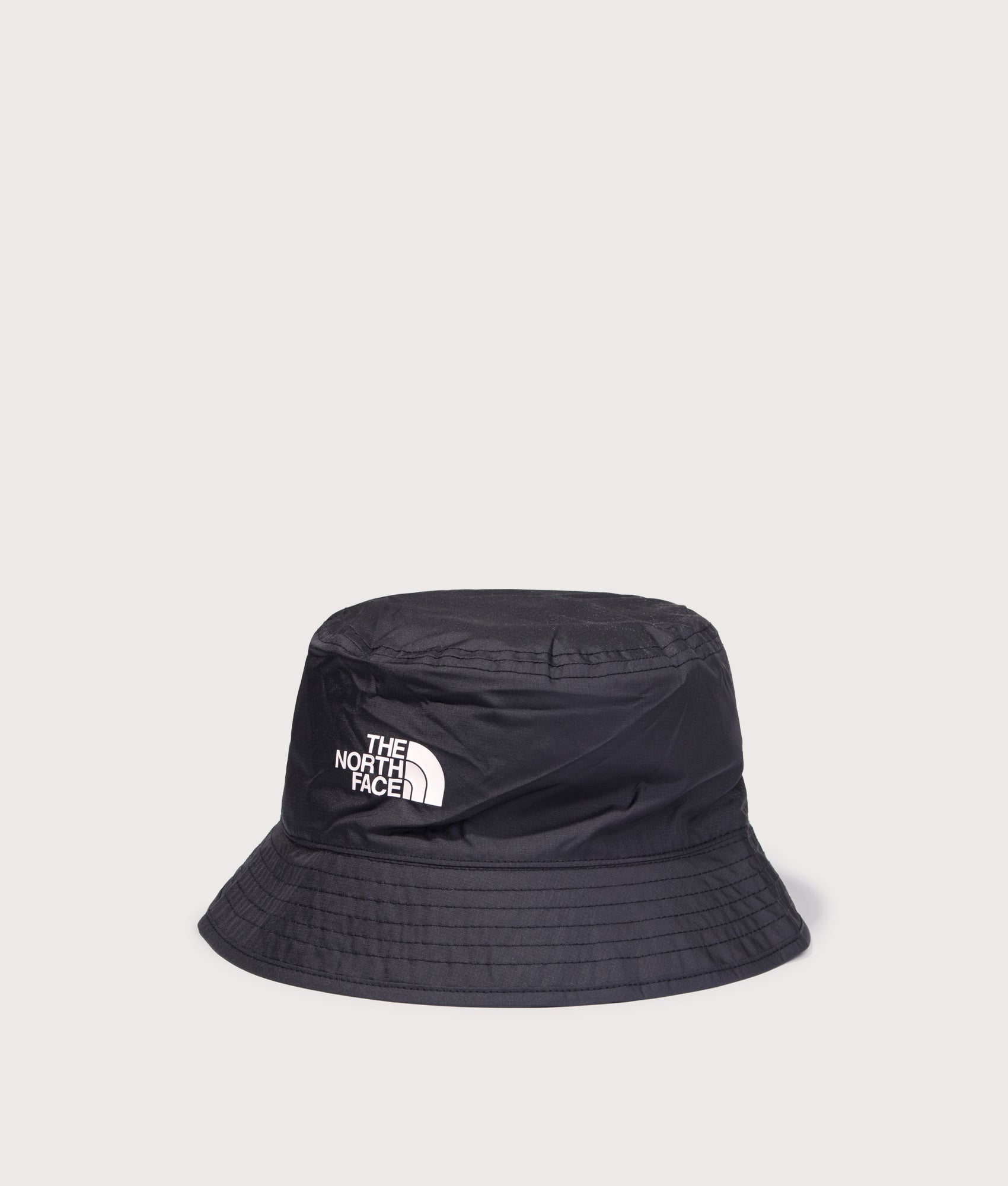 Stash Reversible Bucket Hat in TNF Black/TNF White by The North Face. Shot by EQVVS. Front angled shot.