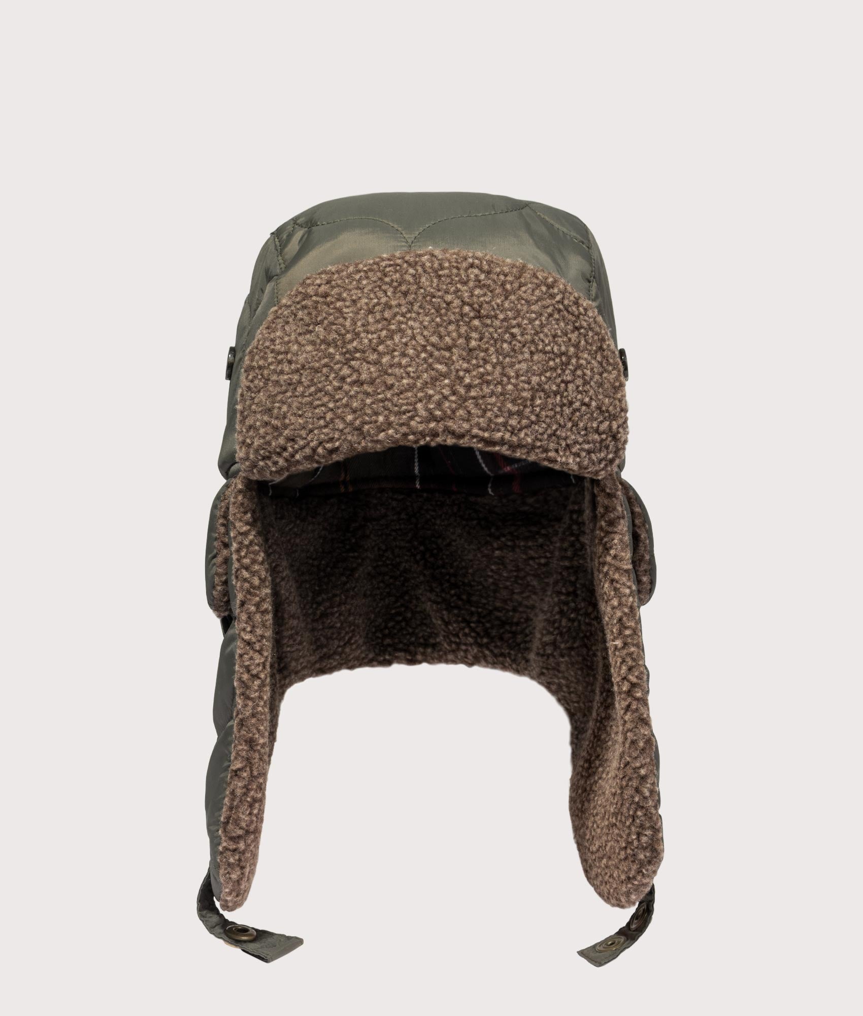 Barbour Sandbay Quilted Trapper Cap in Olive at EQVVS Menswear. Front shot.