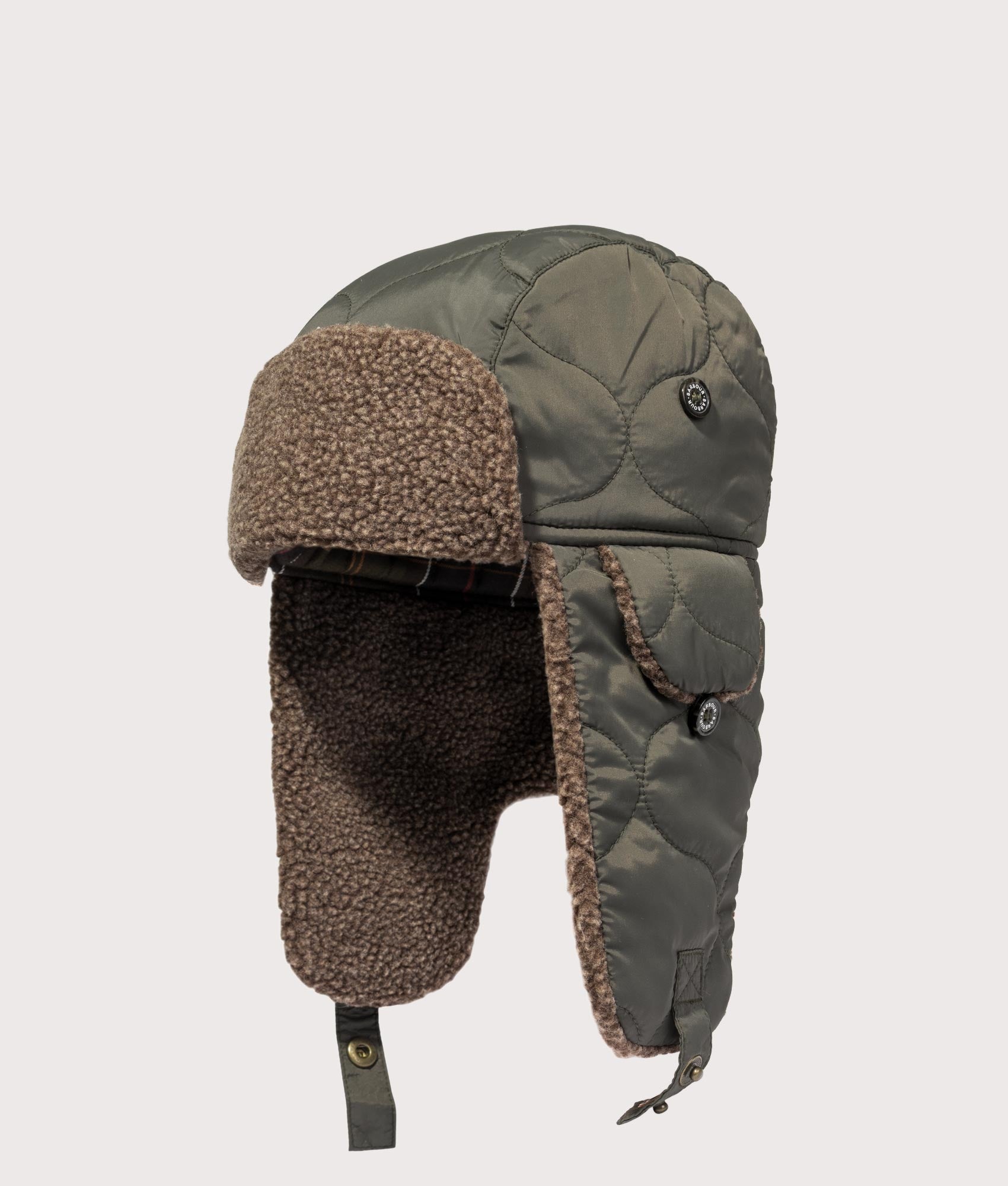 Barbour Sandbay Quilted Trapper Cap in Olive at EQVVS Menswear. Angled front shot.