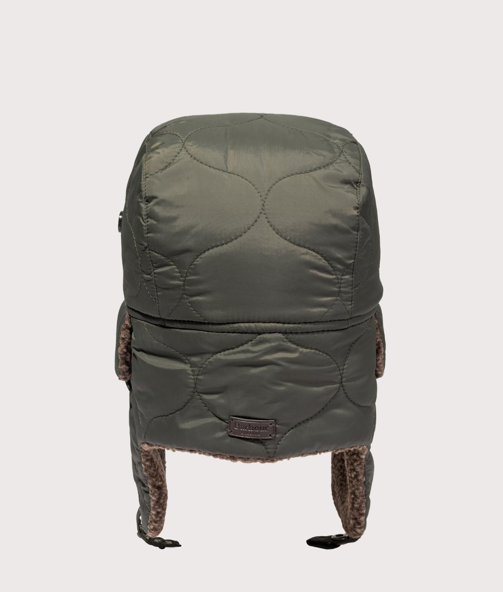 Barbour Sandbay Quilted Trapper Cap in Olive at EQVVS Menswear. Back shot.