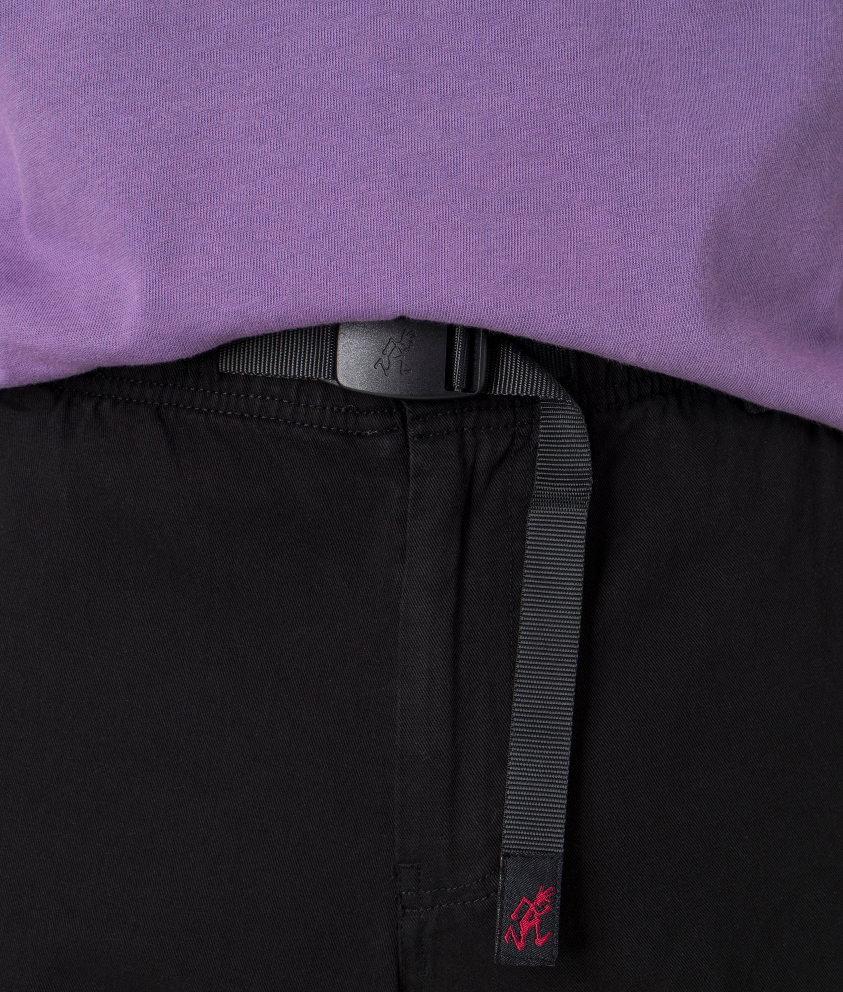 Gramicci Relaxed Fit Rig Cargo Pants in Black, 100% Organic Cotton. At EQVVS Menswear. Front waist close up shot.