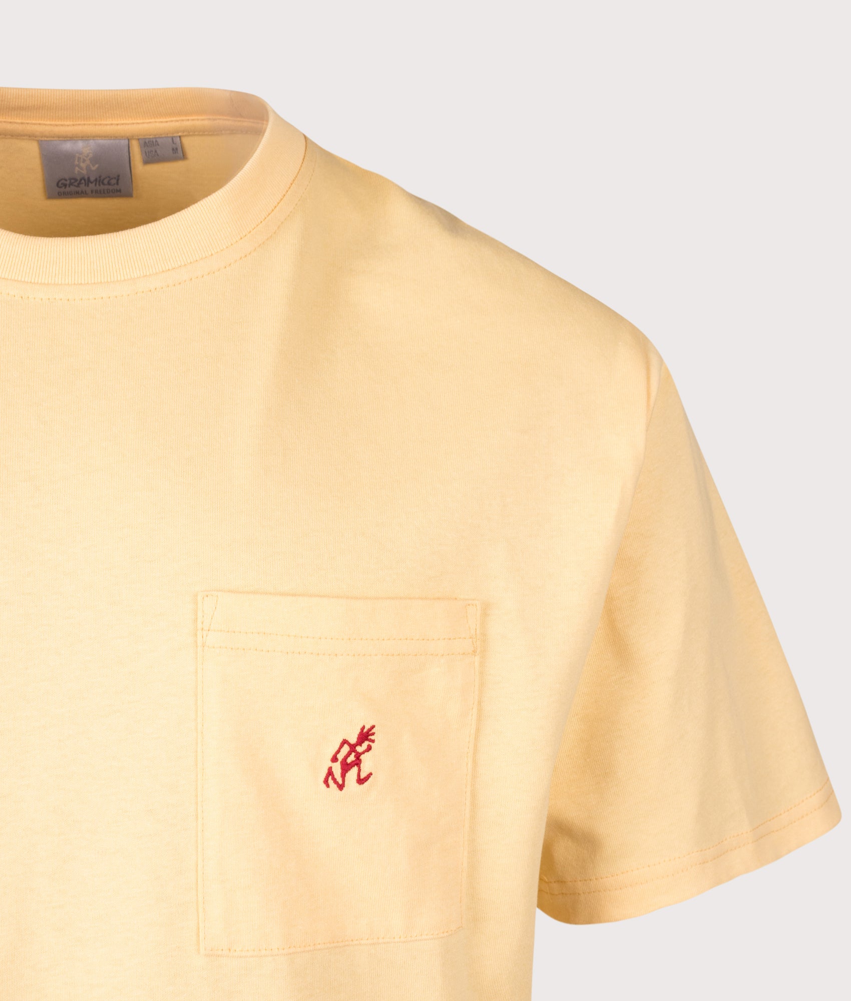 Gramicci One Point T-Shirt in Mango at EQVVS Menswear. Detail shot.