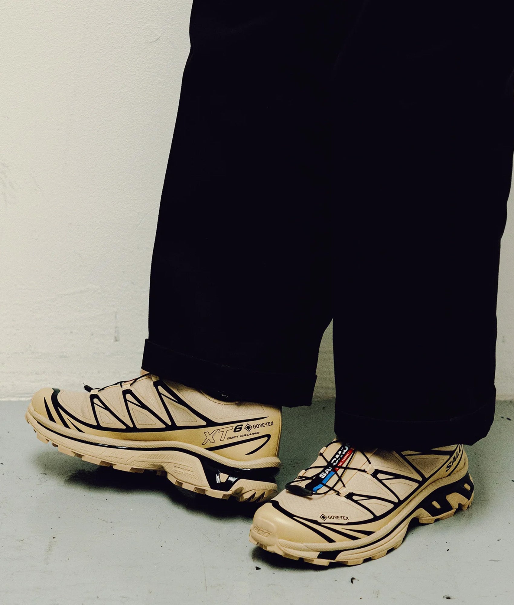 SALOMON XT-6 GTX Sneakers in Safari and Black at EQVVS Menswear. Model front shot.