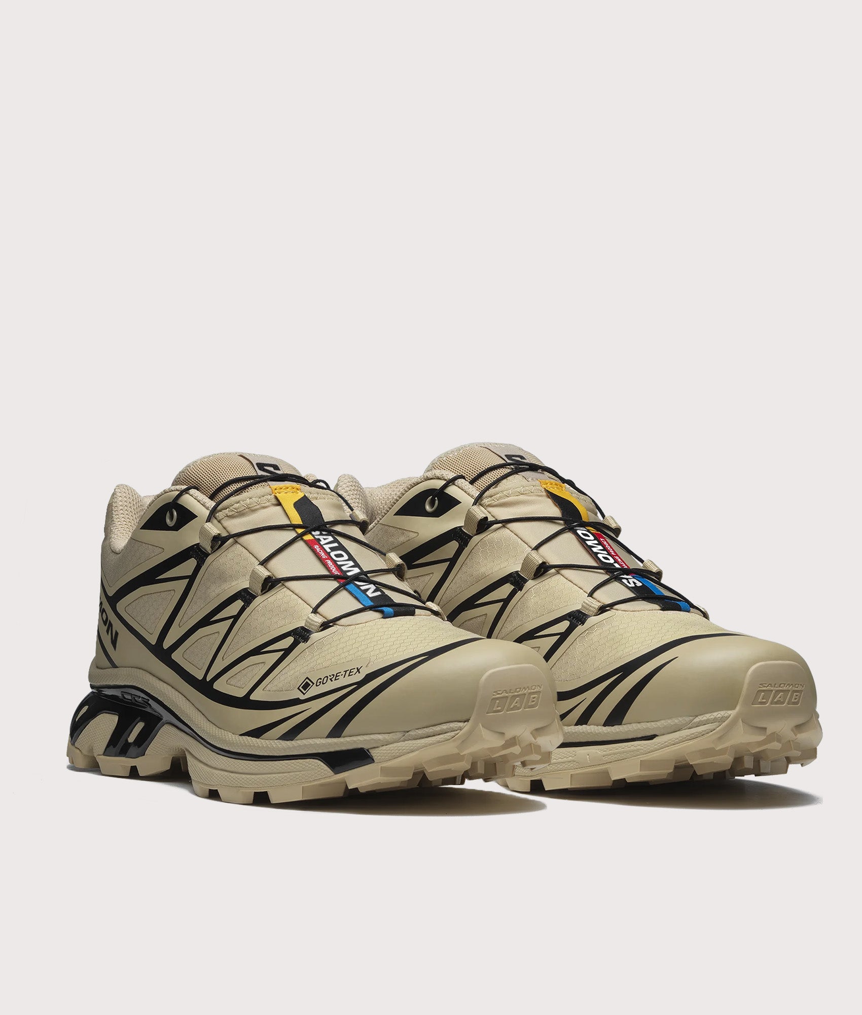 SALOMON XT-6 GTX Sneakers in Safari and Black at EQVVS Menswear. Angled front shot.