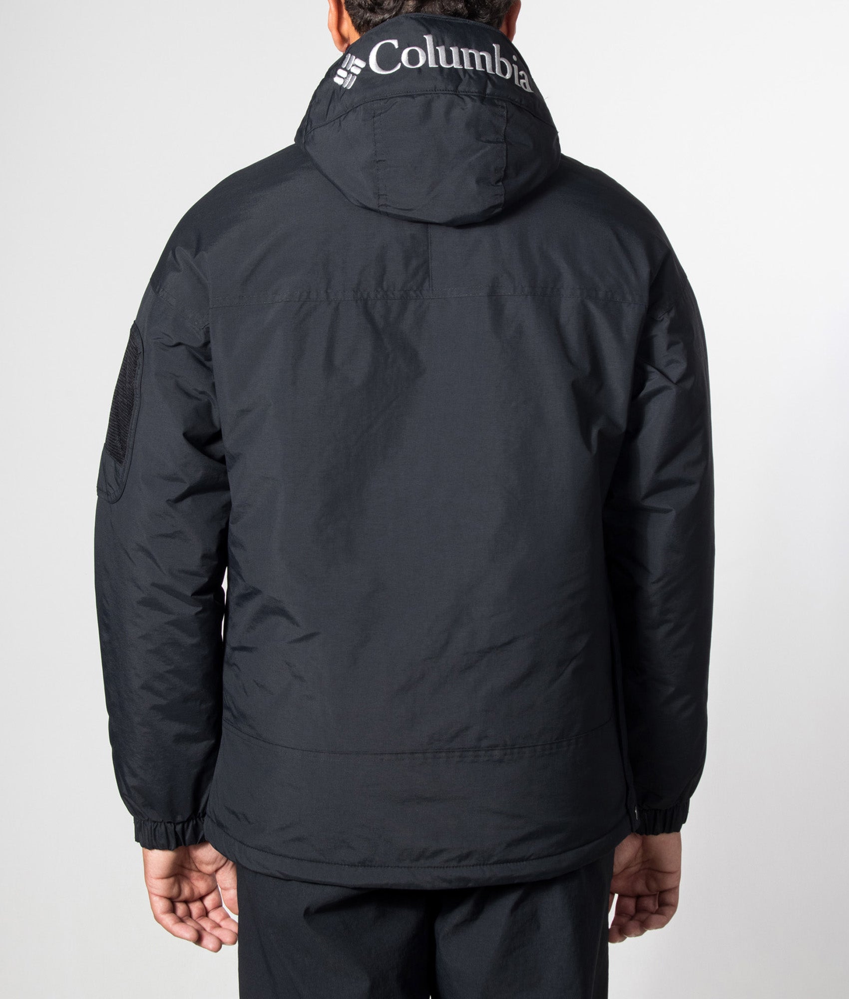 Columbia Challenger II Insulated Pullover Jacket in Black at EQVVS Menswear. Model back shot.