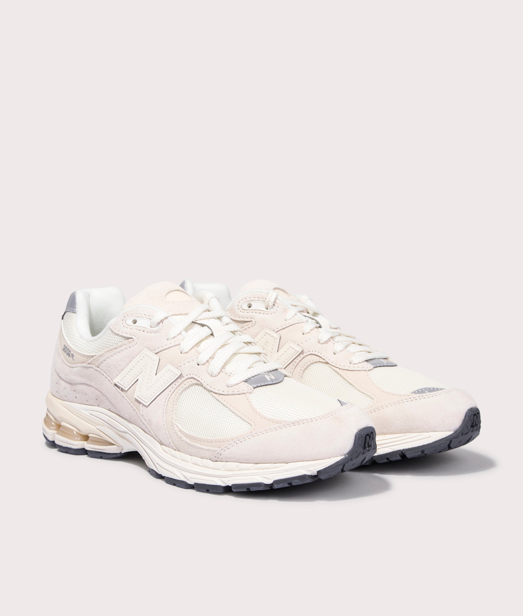 New Balance 2002R Sneakers in Calm Taupe. Side angle shot at EQVVS.