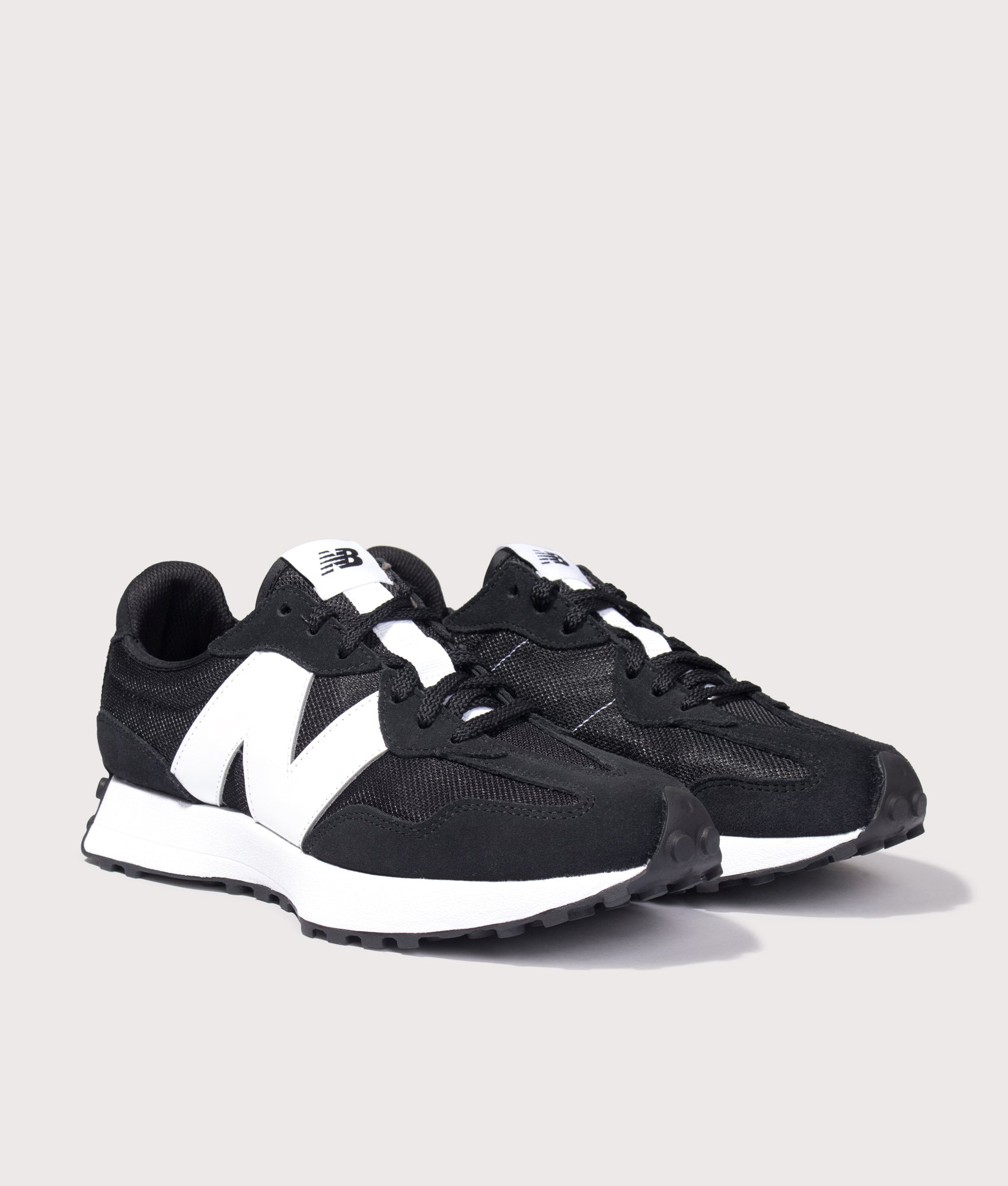 New Balance 327 Sneakers in Black at EQVVS Menswear. Angled front shot.