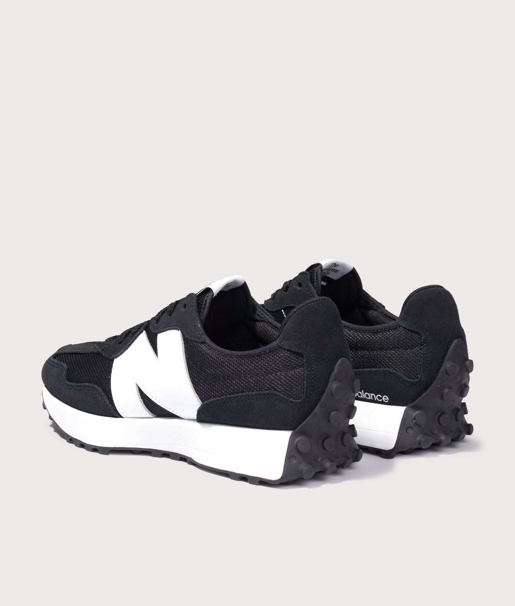New Balance 327 Sneakers in Black at EQVVS Menswear. Angled back shot.