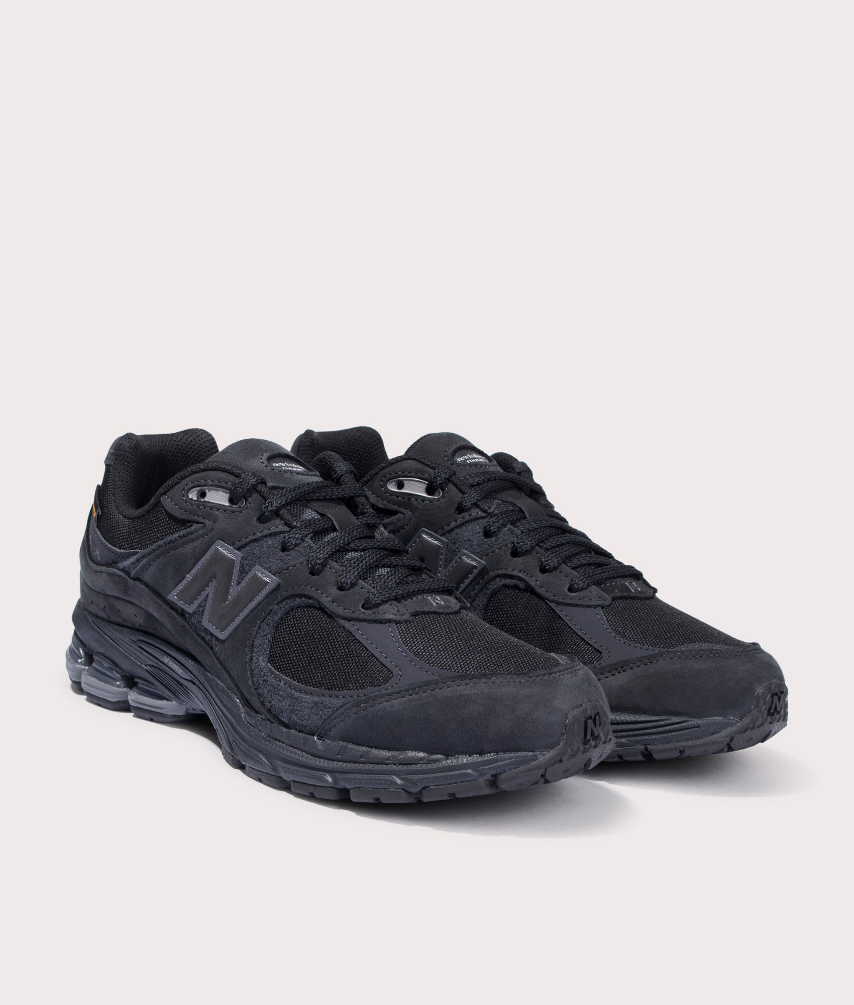 New Balance 2002R Sneakers in Phantom. Suede and Textile Upper. At EQVVS Menswear. Front right angle shot