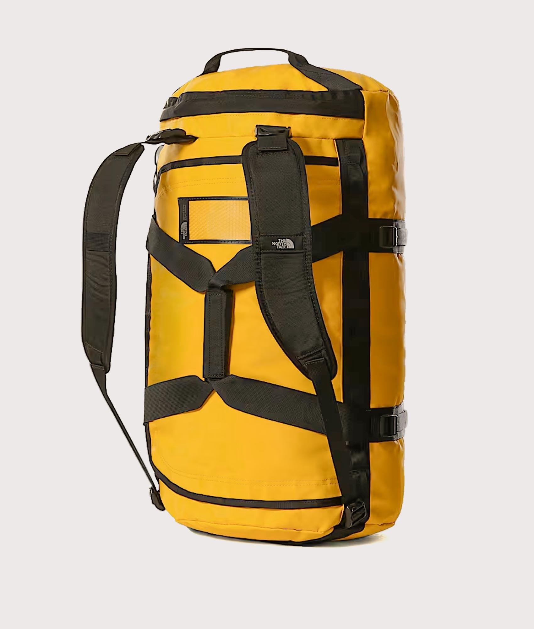 The North Face Large Base Camp Duffel Bag in Summit Gold and TNF Black at EQVVS Menswear. Back shot.