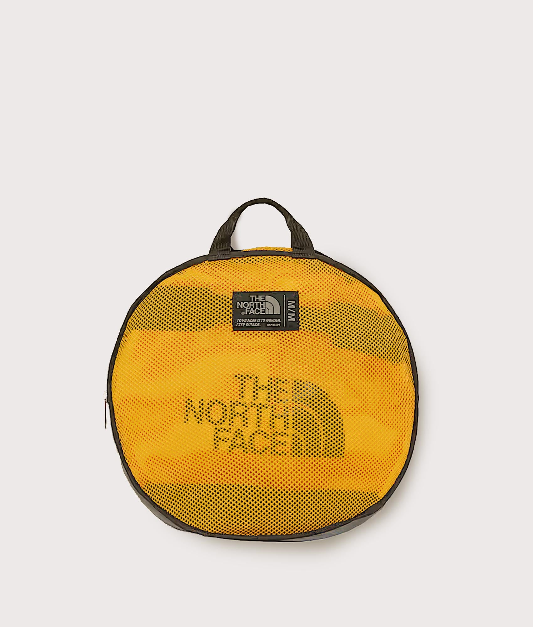 The North Face Large Base Camp Duffel Bag in Summit Gold and TNF Black at EQVVS Menswear. Detail shot.