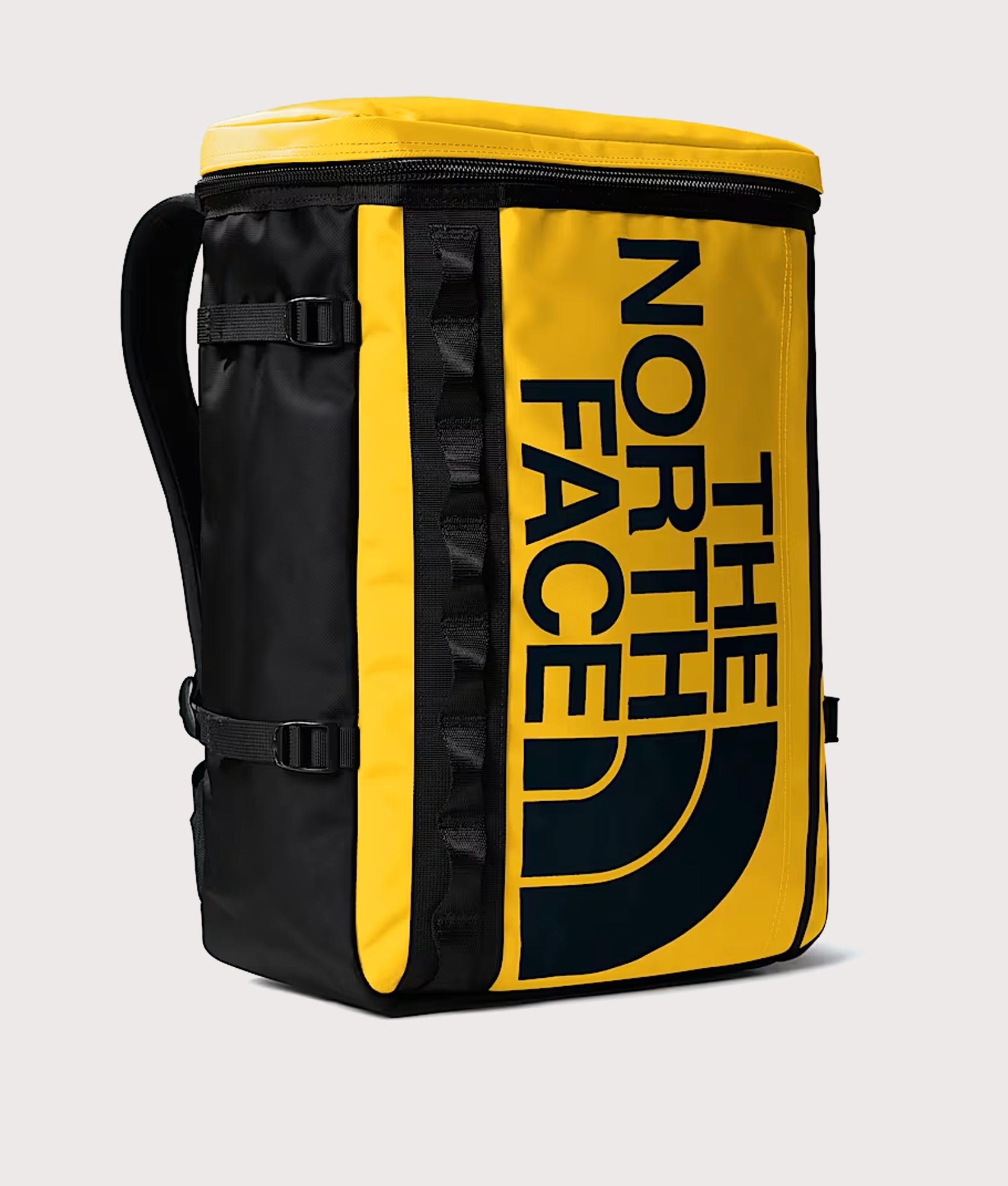 The North Face Fuse Box Backpack in  Summit Gold and TNF Black at EQVVS Menswear. Angled front shot.