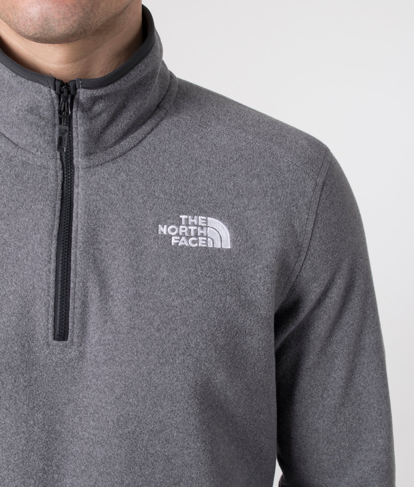 The North Face Quarter Zip 100 Glacier Fleece in Medium Grey Heather. Shot at EQVVS. Detail shot model. 