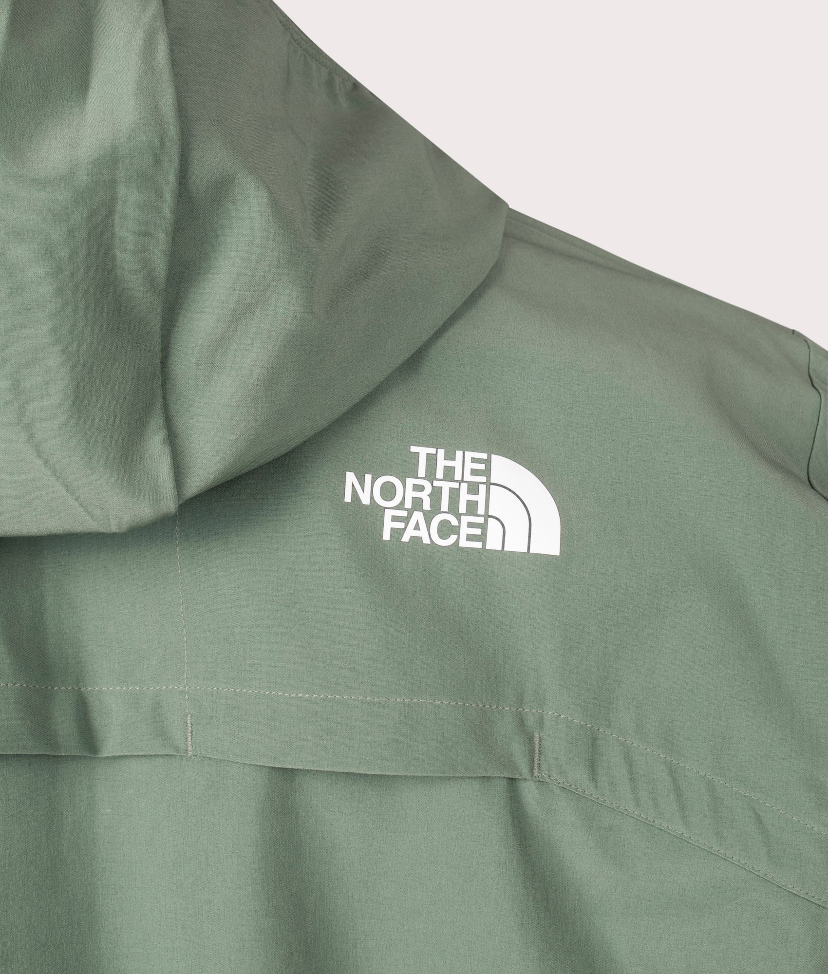 The North Face Mountain Athletic Hooded Wind Jacket in Duck Green. Back Detail Shot at EQVVS.