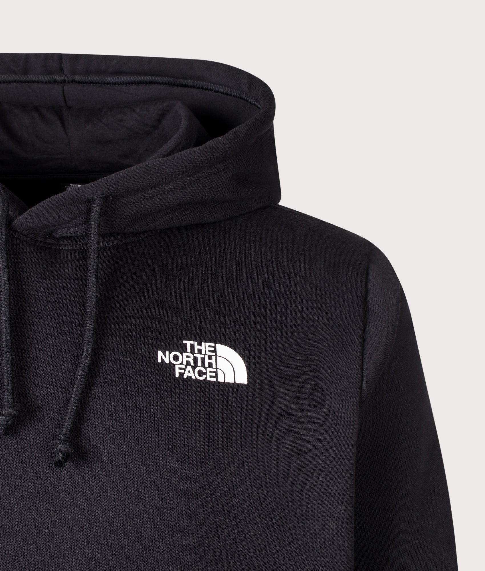 The North Face Regular Fit NSE Evolution Box Half Dome Hoodie in TNF Black at EQVVS Menswear. Detail shot.
