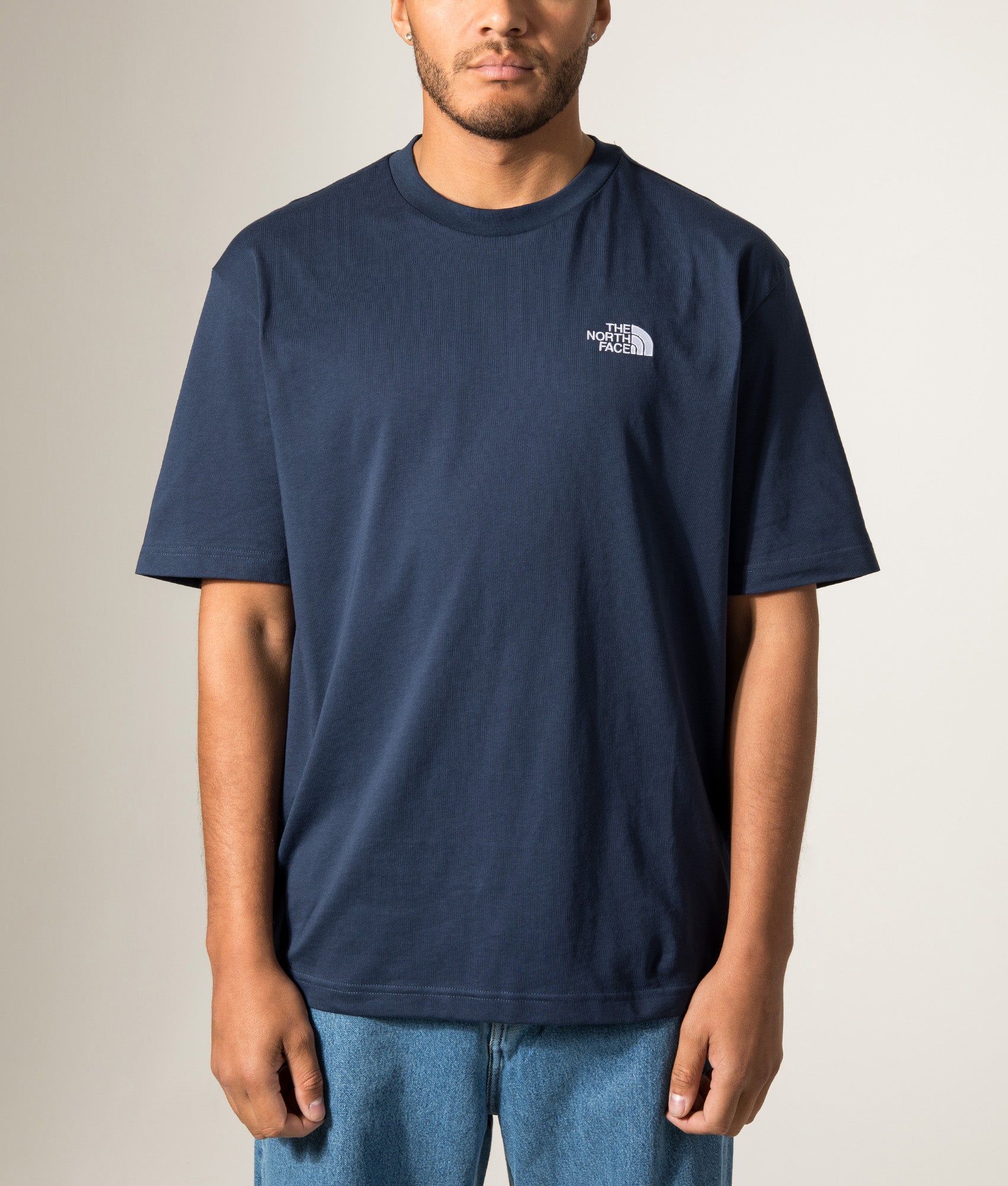 The North Face Essential Oversized T-Shirt in Summit Navy at EQVVS Menswear. Model front shot.