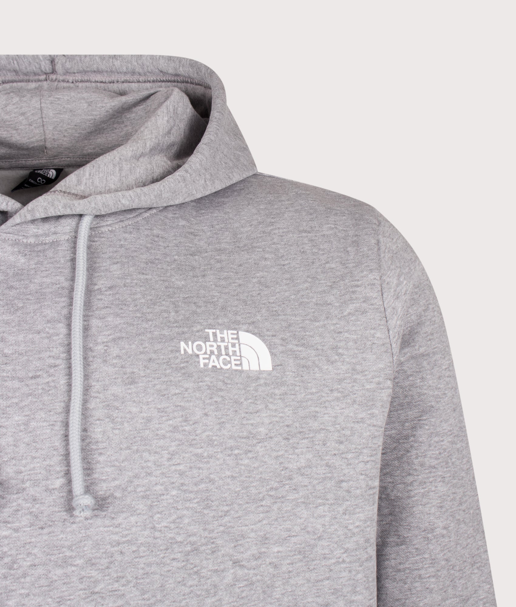 The North Face Regular Fit NSE Evolution Box Hoodie in TNF Pale Grey Heather at EQVVS Menswear. Detail shot.