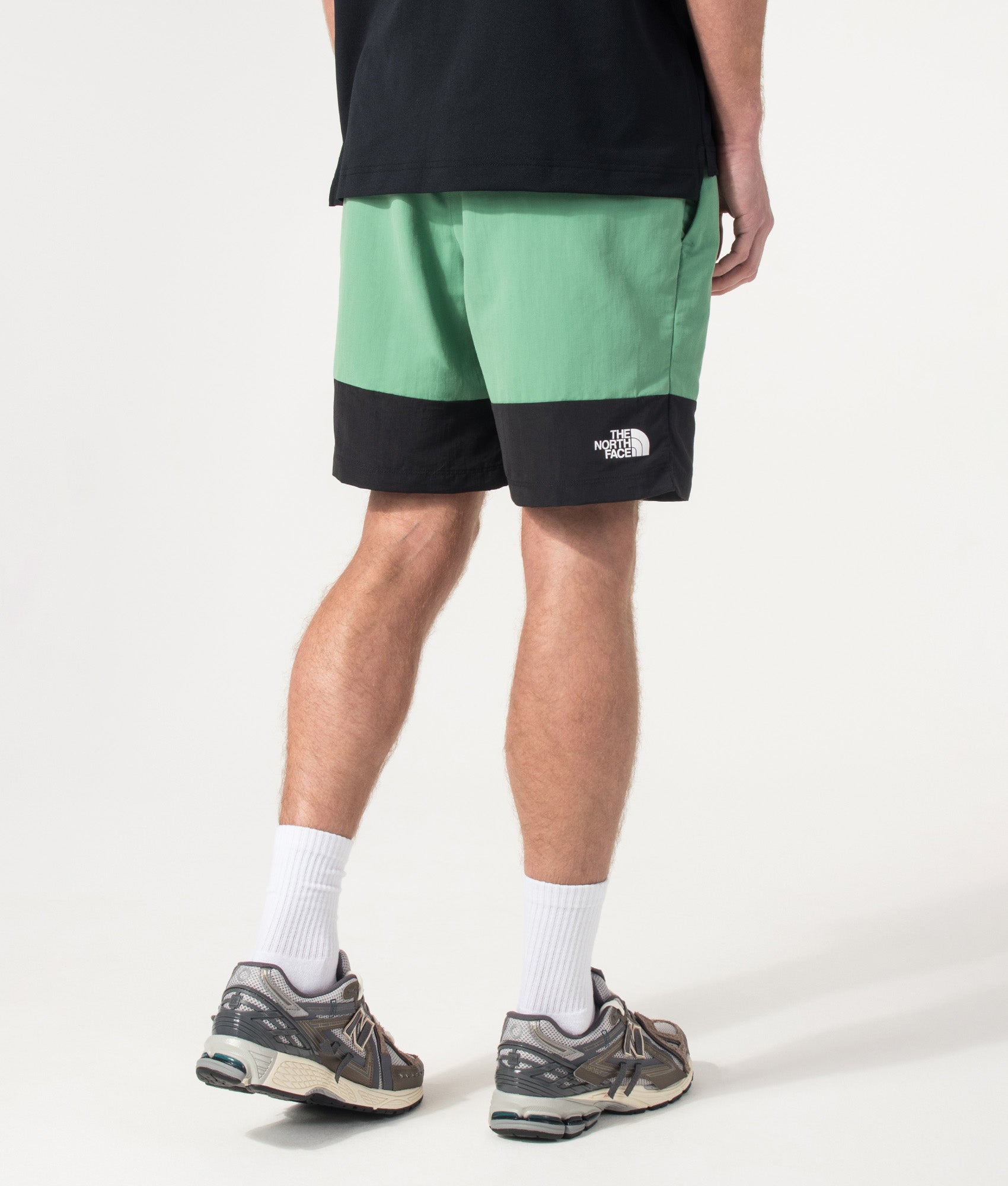 The North Face Leynar Shorts in Dimmed Algae and TNF Black at EQVVS Menswear. Angled model back shot.
