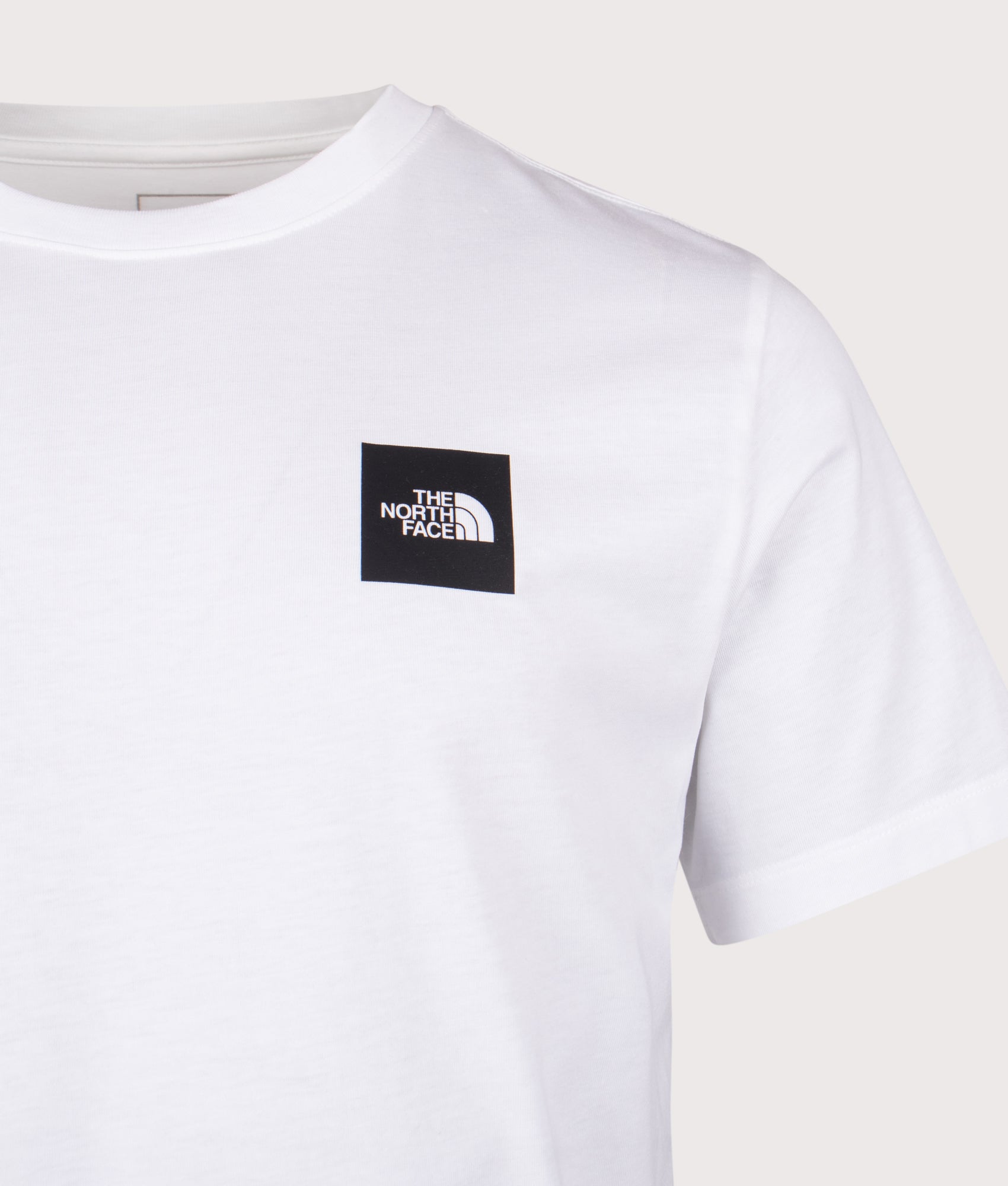 The North Face Evolution Box Half Dome T-Shirt in TNF White at EQVVS Menswear. Front detail shot.