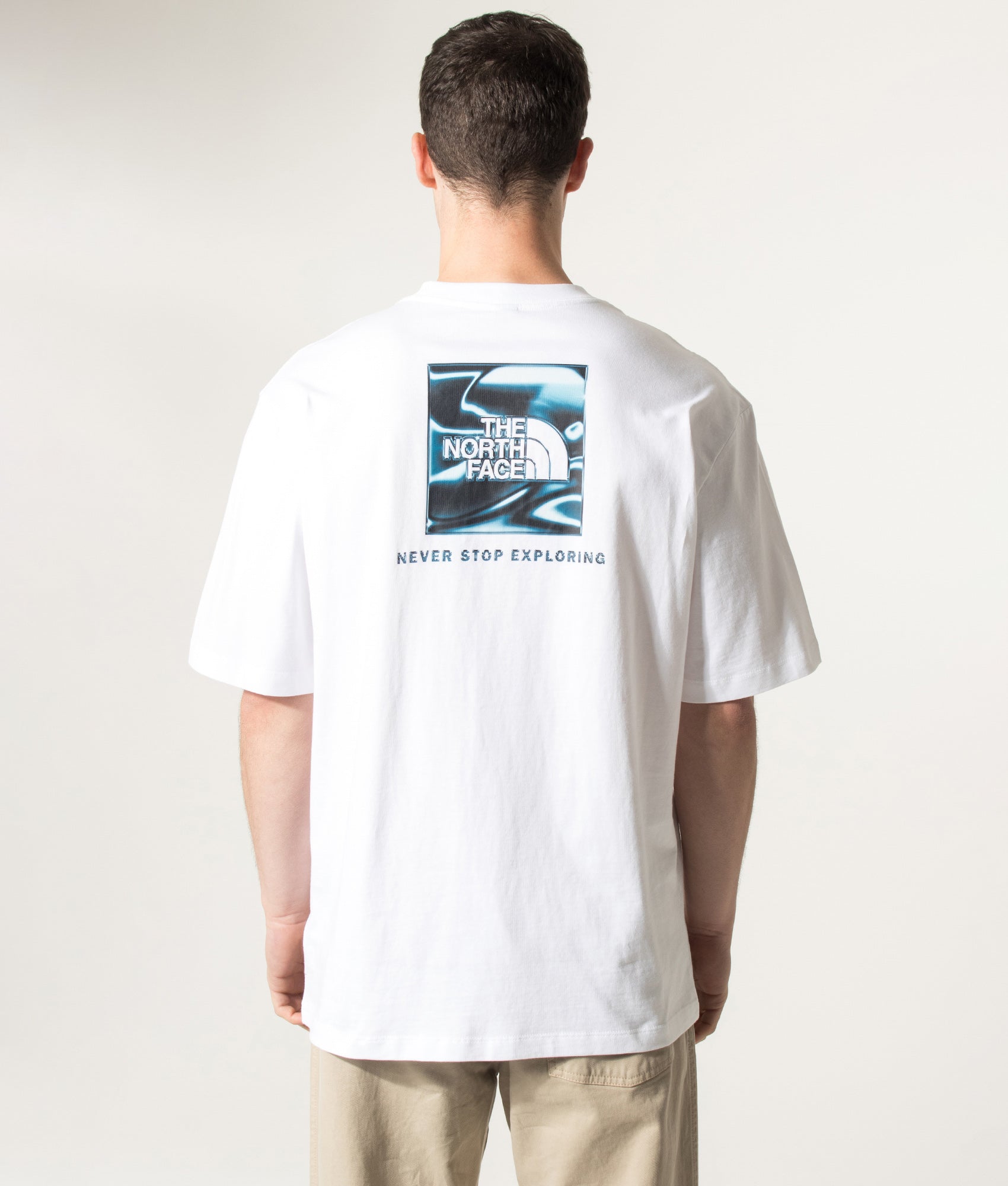 The North Face Oversized Liquid NSE Box Graphic T-Shirt in TNF White at EQVVS Menswear. Model back shot.